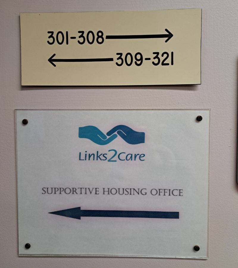 Directional sign pointing to the apartments alongside a Links2Care sign at Lakeview Villa in Acton